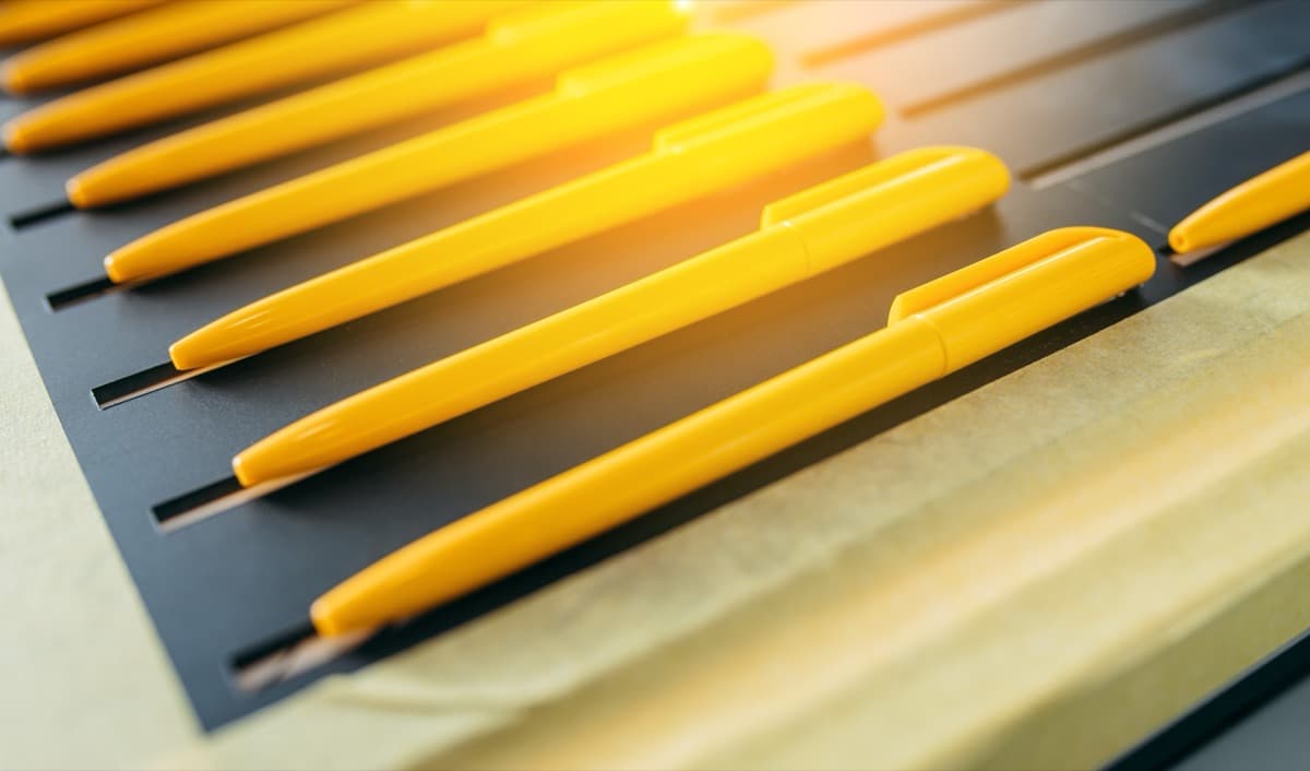 Quality yellow pens arranged in holder perfect for corporate branding