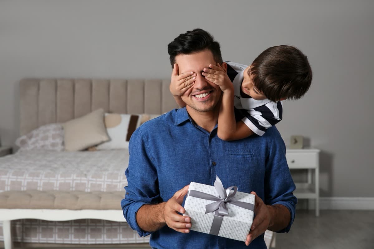 Parent and young child with a wrapped personalised gift