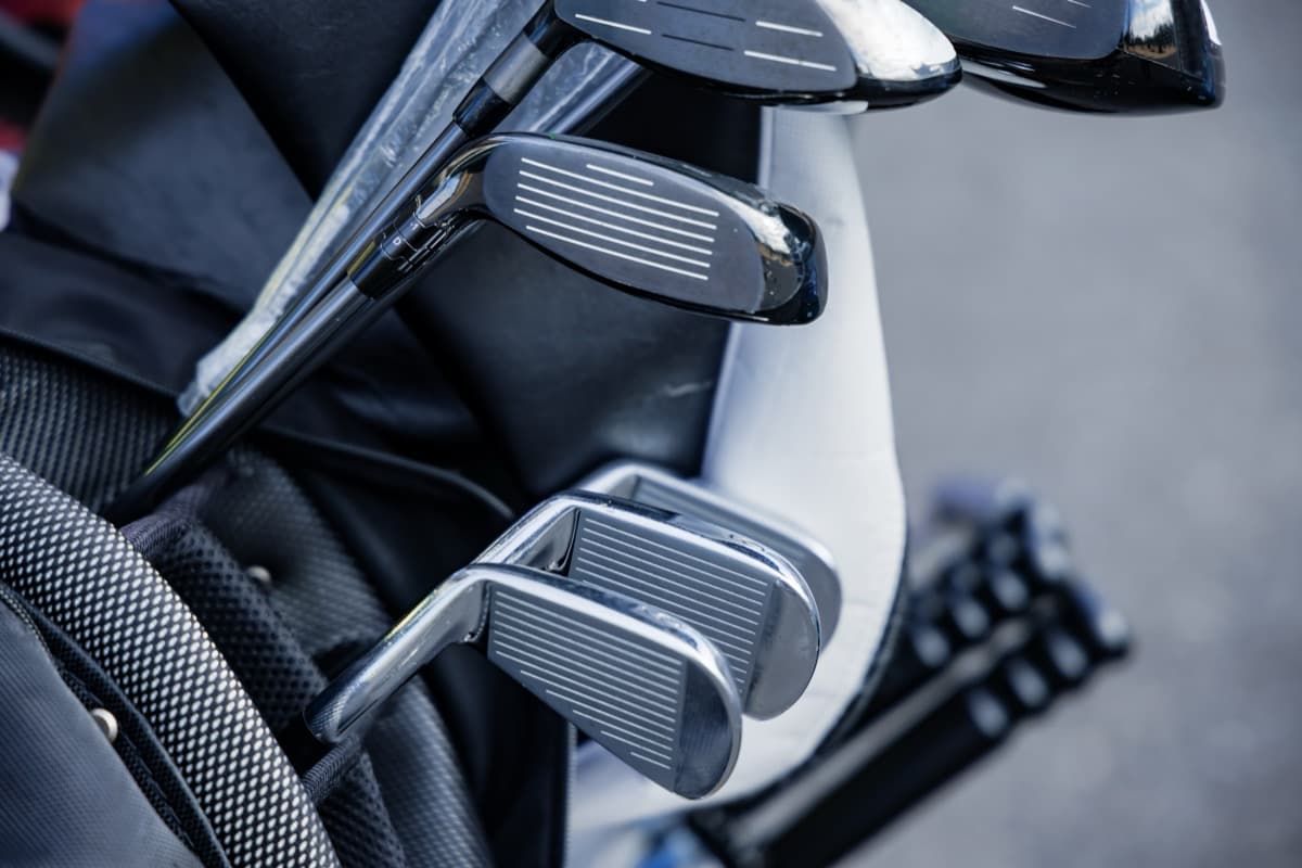 Close-up of golf clubs in bag on golf course