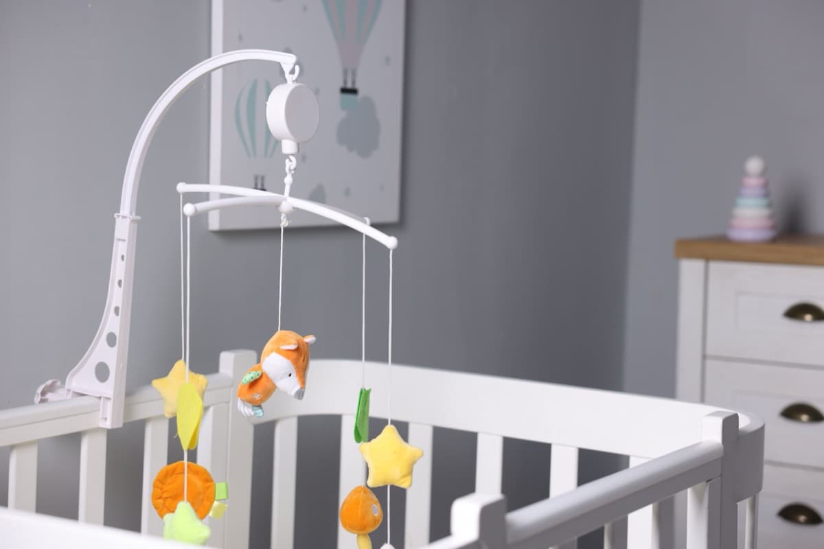 Baby crib mobile in soft pastel nursery