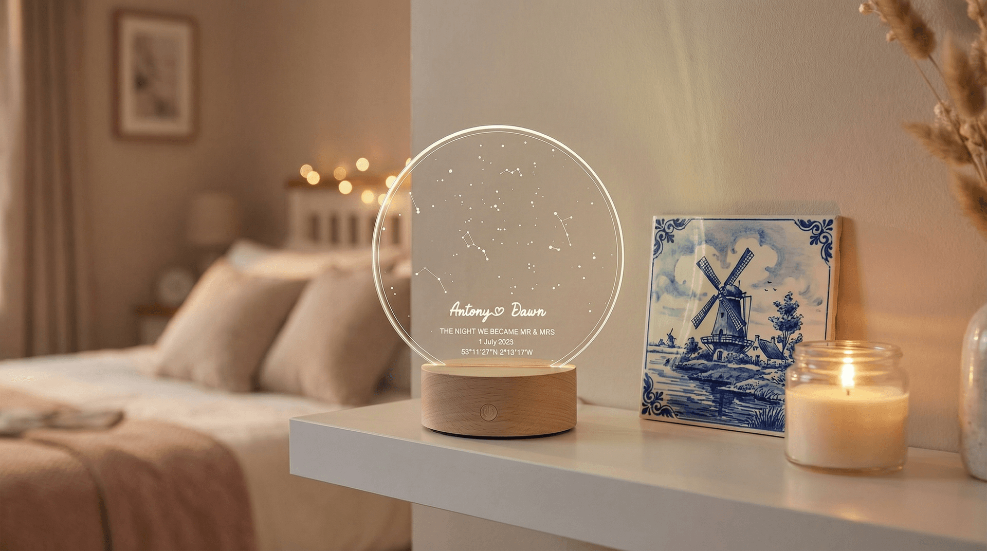 Star map LED night light and Delft Blue custom tile displayed on a white shelf next to a small plant and candle for scale