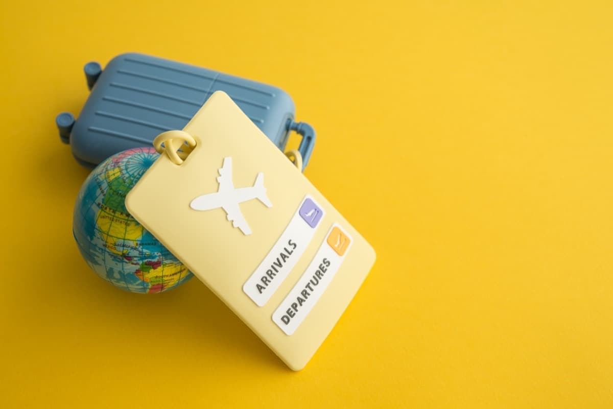Travel suitcase with luggage tag passport and globe for holiday